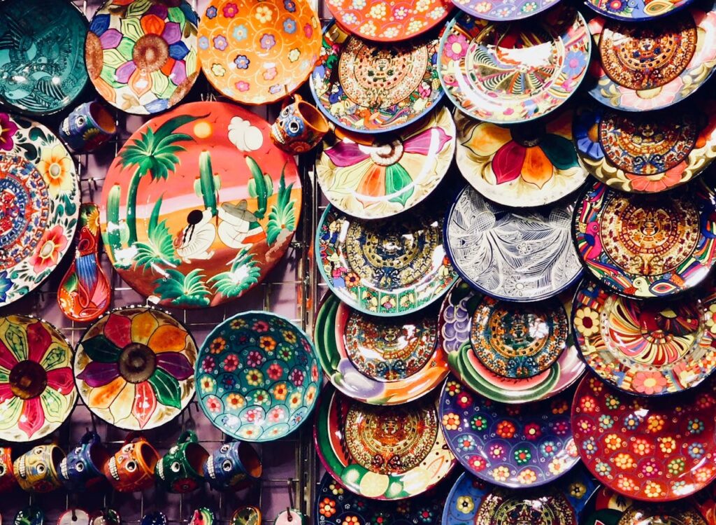 A colorful array of handmade pottery and ceramics displayed at a Dubai market. Ideal for art and craft enthusiasts.